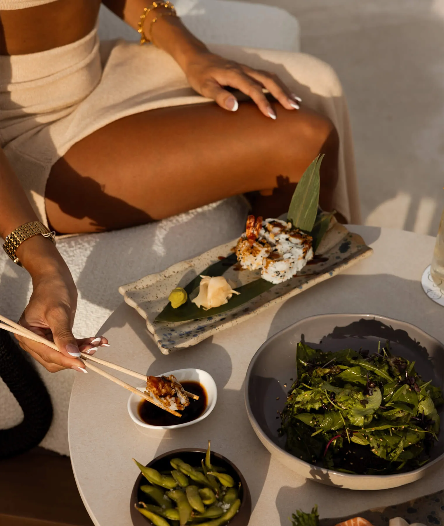 Guests savoring a sushi dinner at The Lounge, with fresh seafood dishes and panoramic views of the Aegean Sea.
