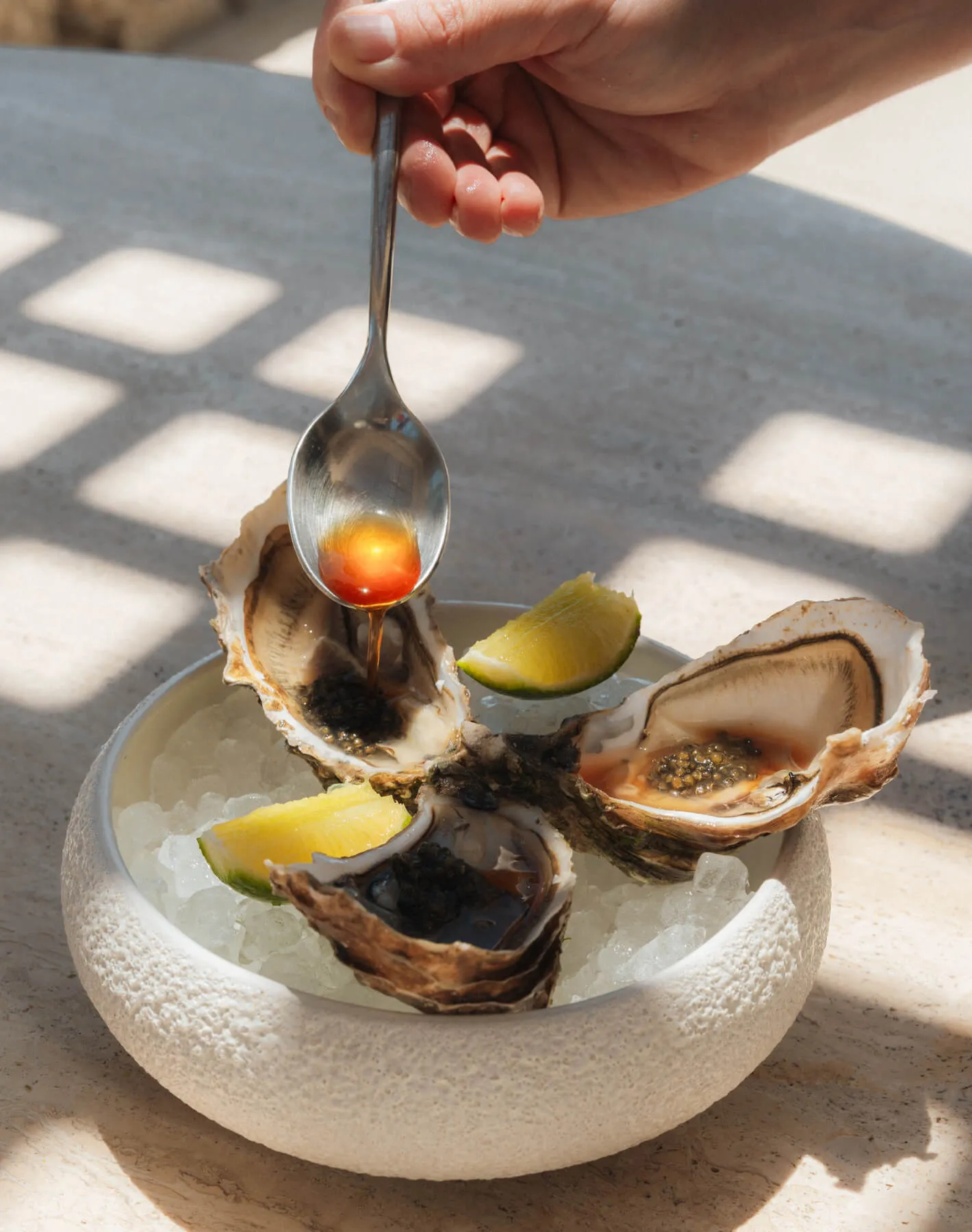 At Cali Mykonos, indulge in fresh oysters and premium caviar served on ice. This luxurious seafood platter promises a refined dining experience, highlighting the freshest flavors of the sea against a backdrop of elegance and sophistication.