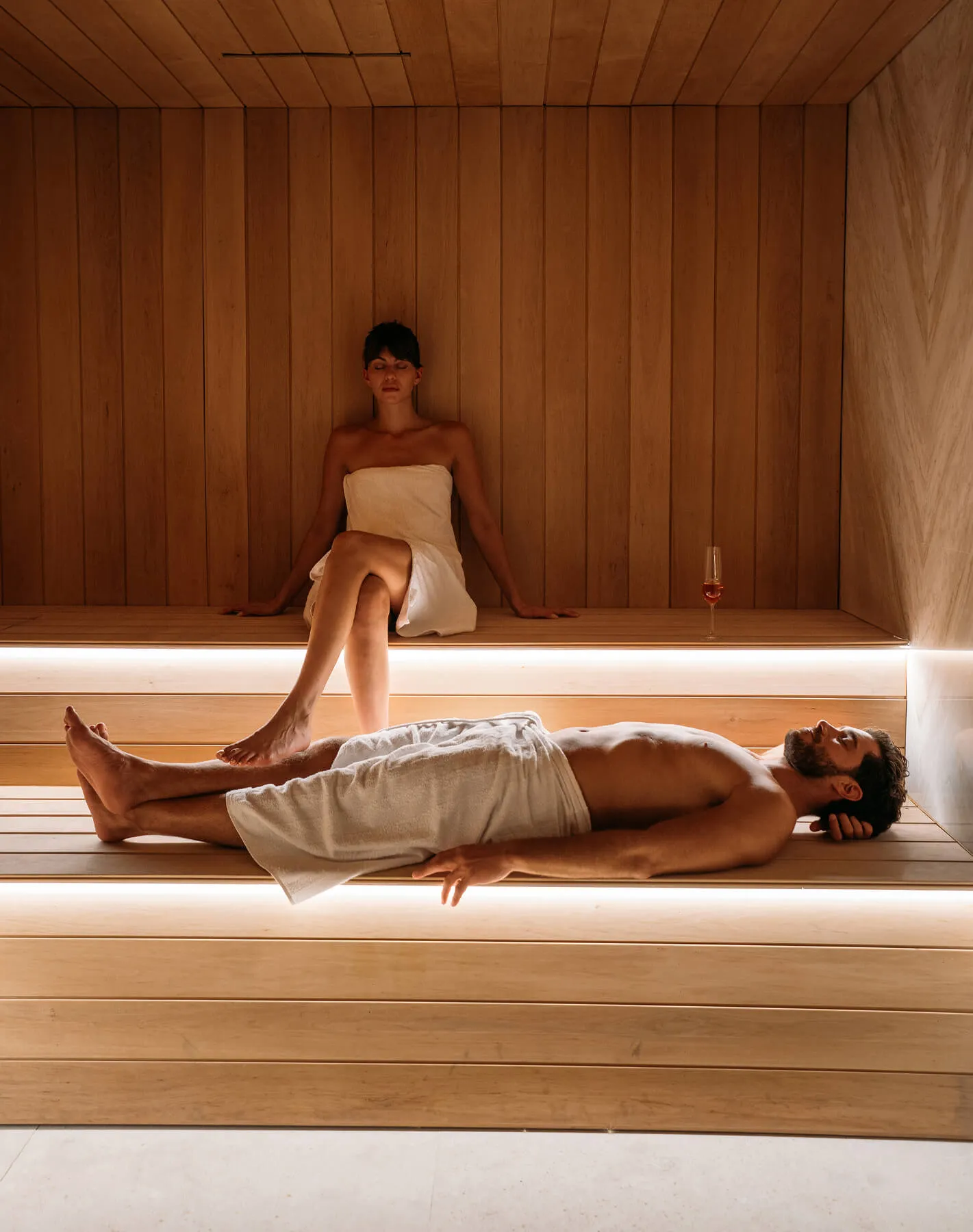 Couple enjoying a wellness retreat in the premium sauna at Cali Mykonos, one of the top luxury resorts in Greece with world-class spa facilities.